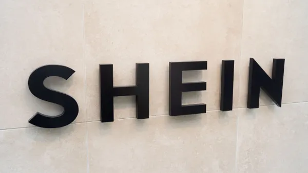 A closeup of a Shein sign on a wall.