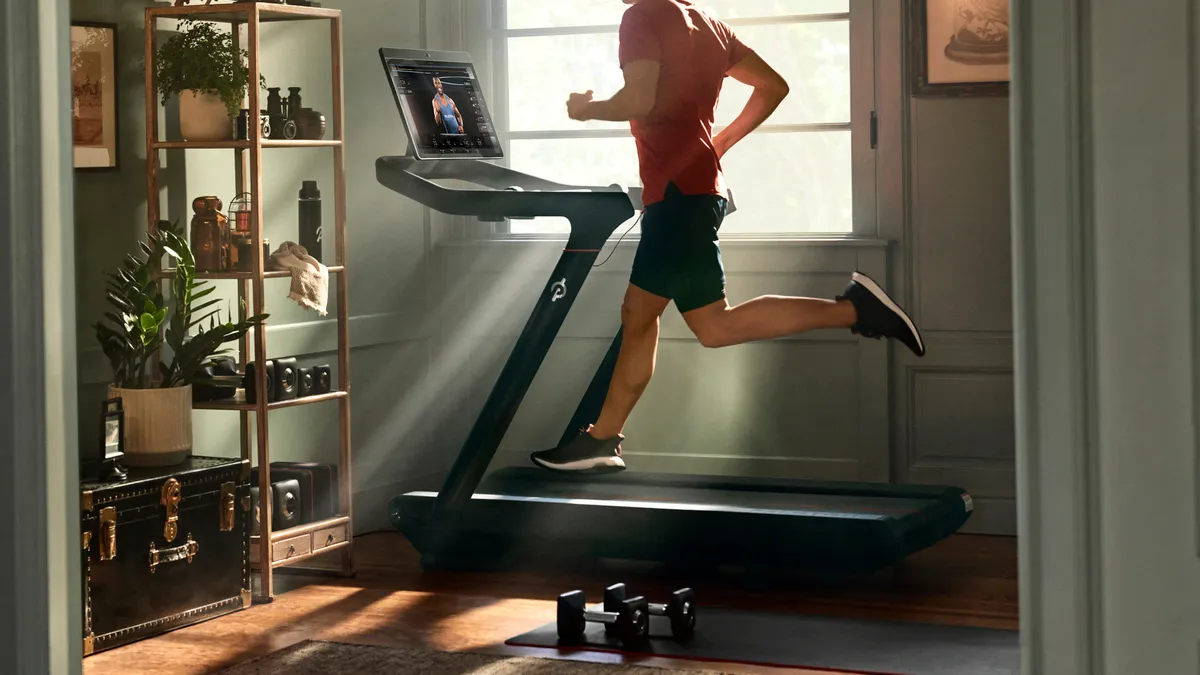 A person running on a Peloton treadmill