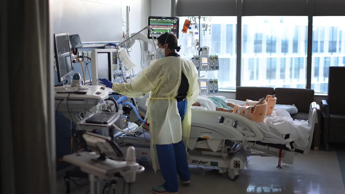 a doctor treats a patient in a hospital bed in front of a window