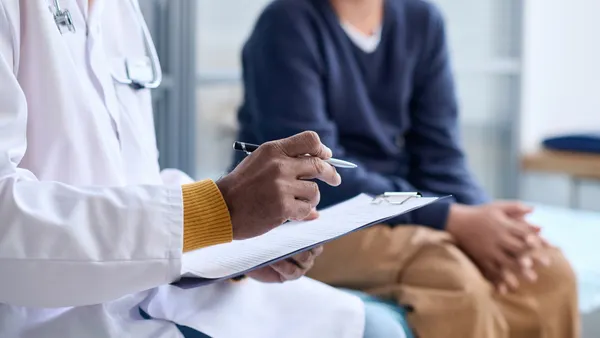 Doctor Holding Clipboard
