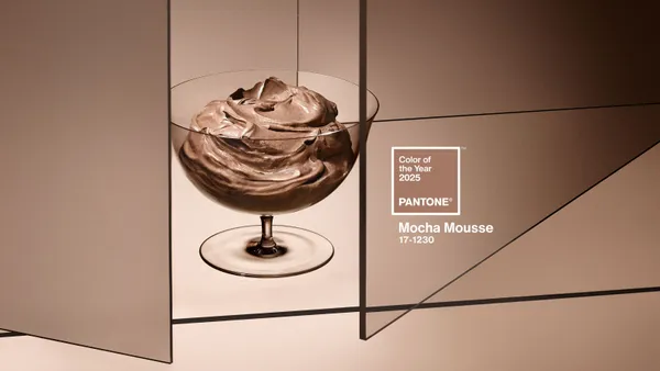 A bowl of chocolate mousse is positioned against a warm brown background with the words Color of the Year 2025 Mocha Mousse on the picture.