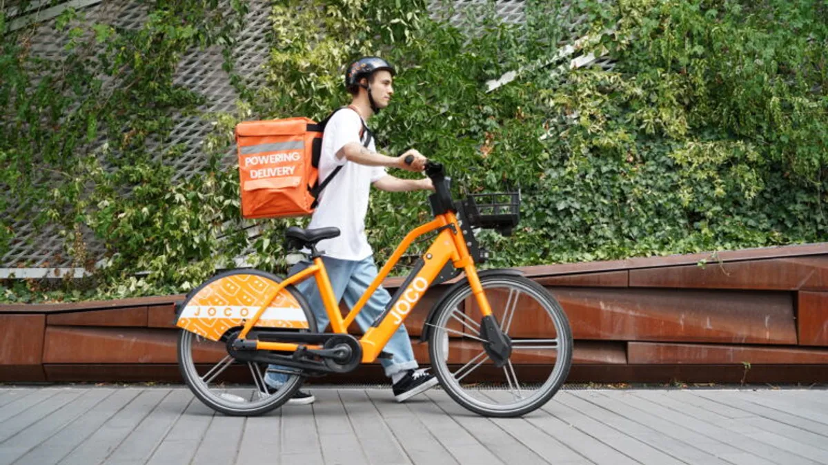 A Grubhub worker and a JOCO bike.