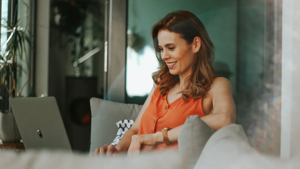 Smiling women browsing laptop