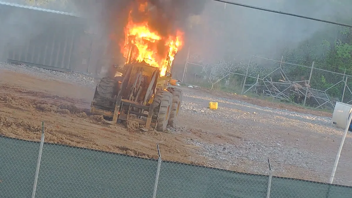 A bulldozer burns at a construction site.