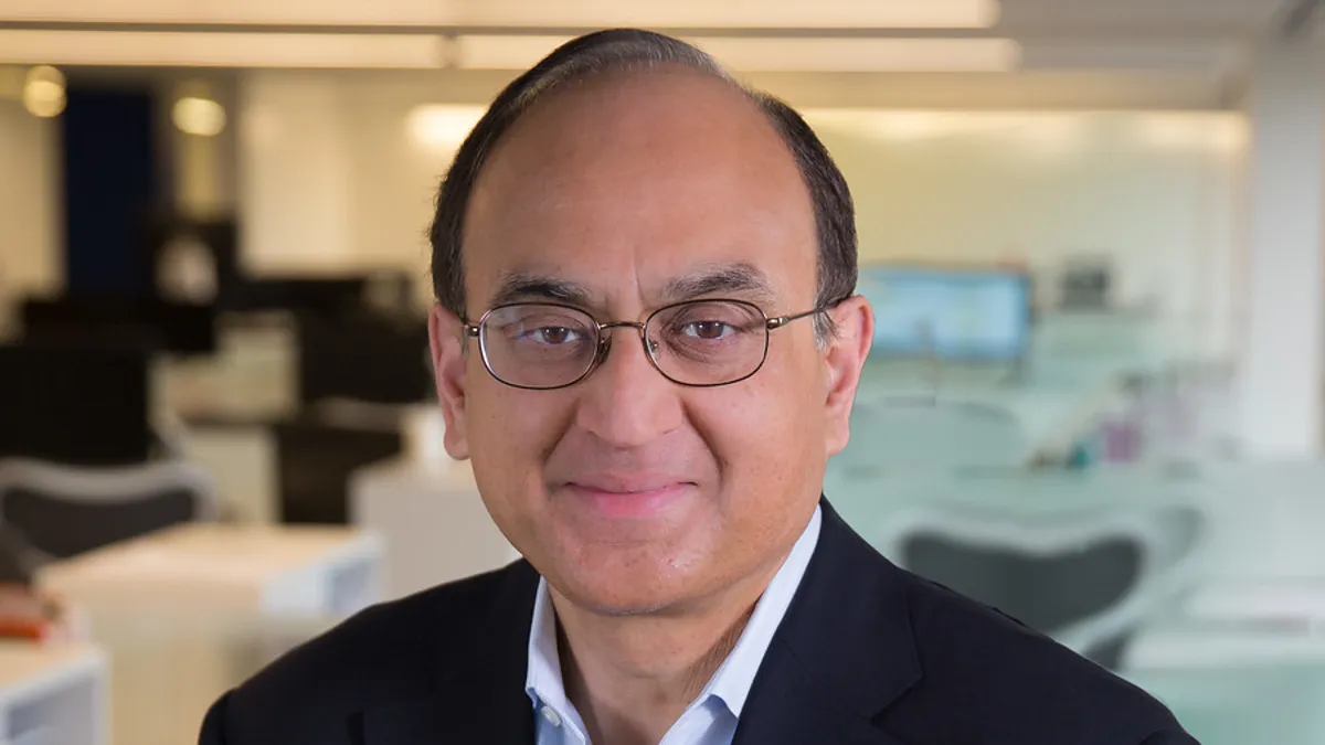 Corporate head shot of man in suit.