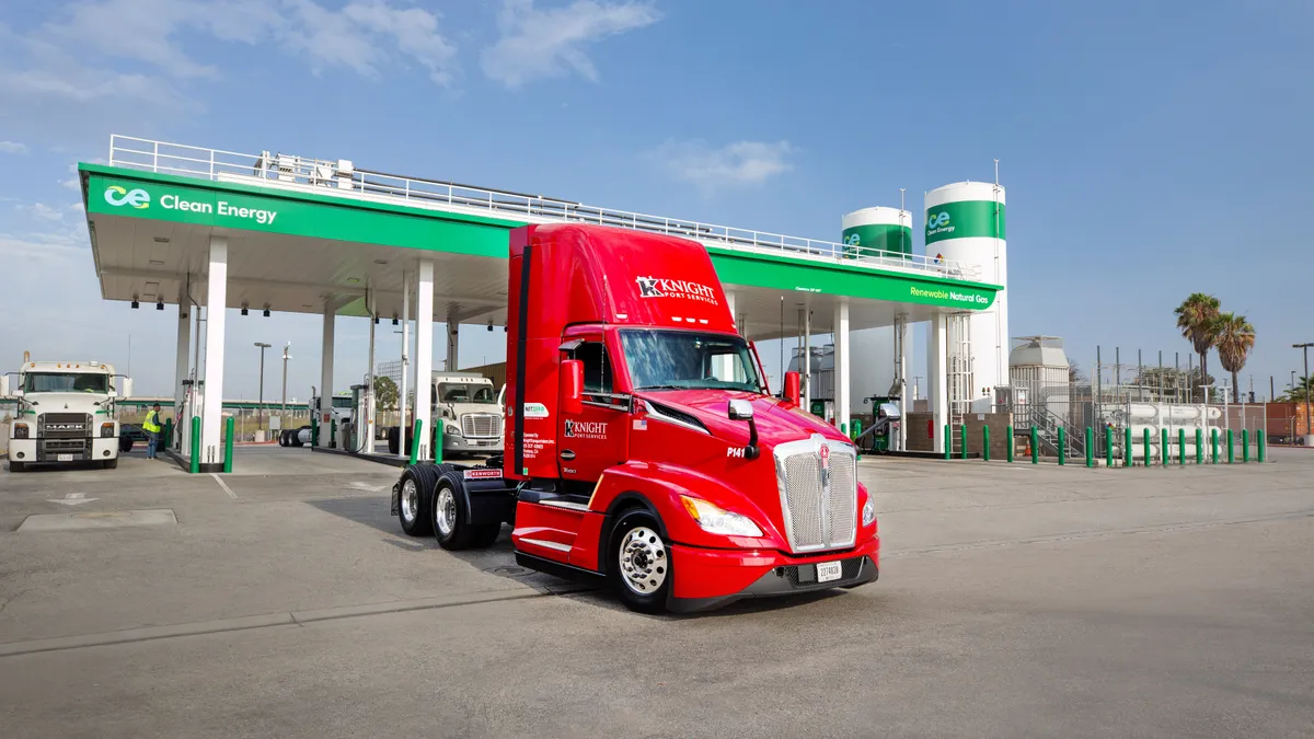 A Knight Transportation truck by a natural renewable gas station.