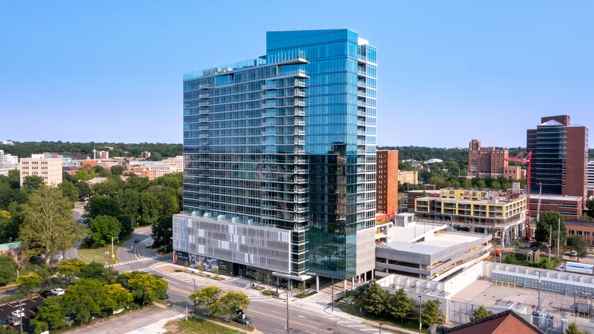 A glass and steel apartment tower.