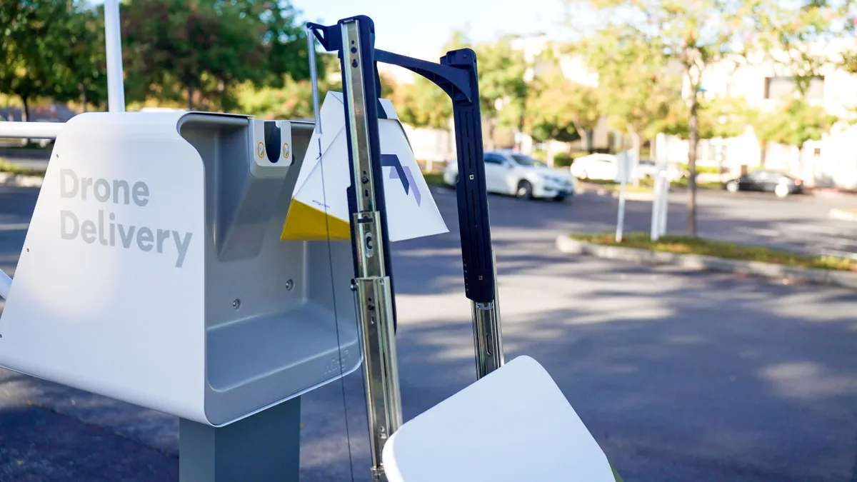 A Serve Robotics robot brings a package to an "AutoLoader" station for drone delivery.