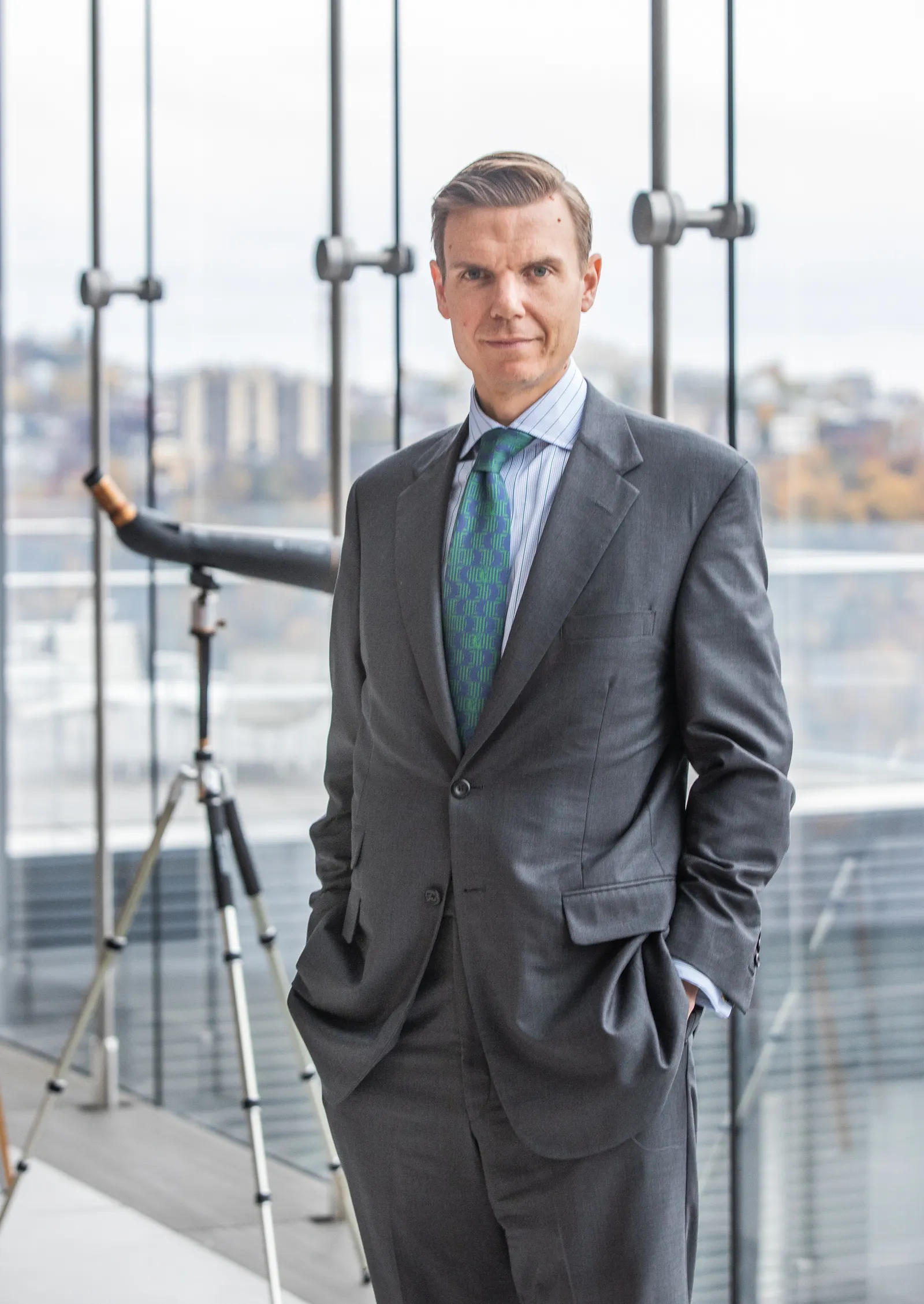 PNC executive Alex Overstrom stands in front of a wall of windows.