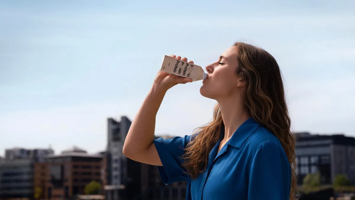 Person drinking a protien drink