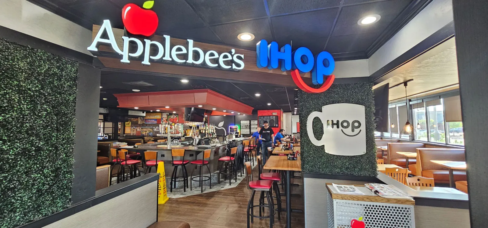 An interior of a restaurant with signs that say Applebee's and IHOP