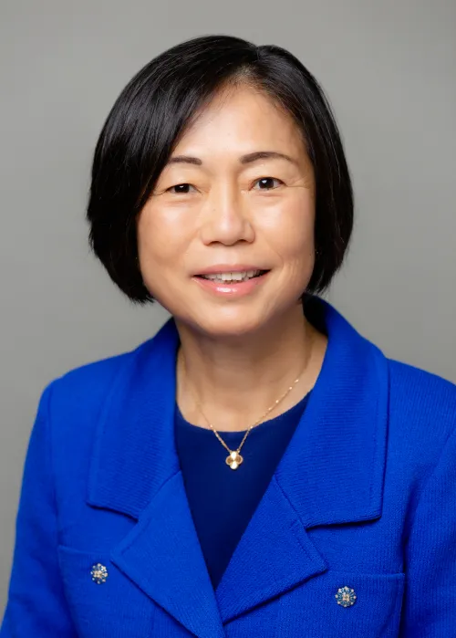 Dr. Keting Chu in blue blazer against a gray backdrop