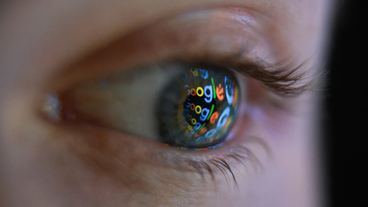 In this photo illustration, an image of the Google logo is reflected on the eye of a young man on August 09, 2017 in London, England.