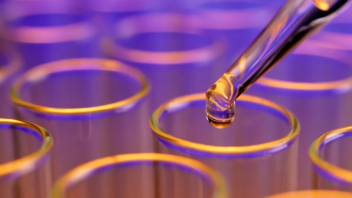 Liquid drop falling into test tubes.