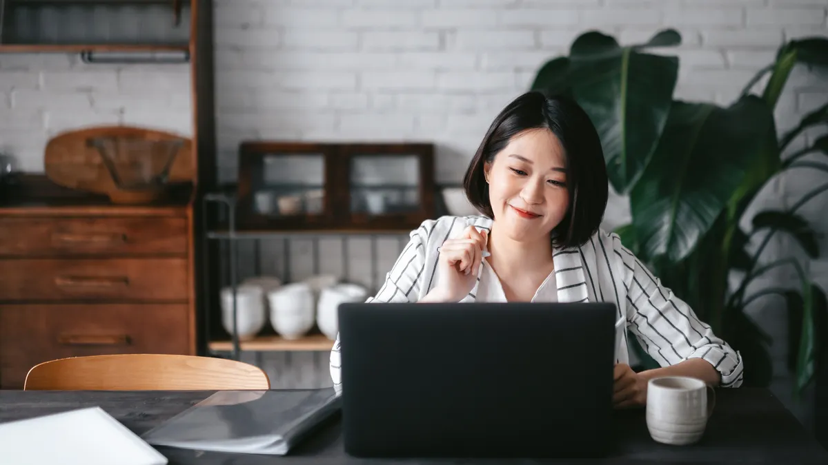 A young lawyer works on a laptop in their home office