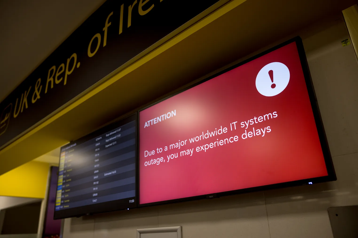 A screen warns airport passengers of potential delays due to a worldwide IT systems outage