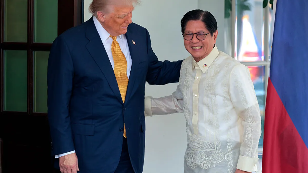 U.S. President Donald Trump greets Philippine President Ferdinand Marcos Jr. at the White House. Trump has his hand on the back of Marcos.