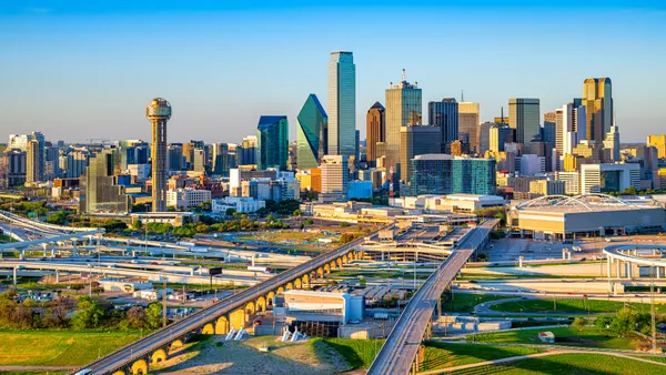 The Dallas, Texas skyline shows skyscrapers and highways.