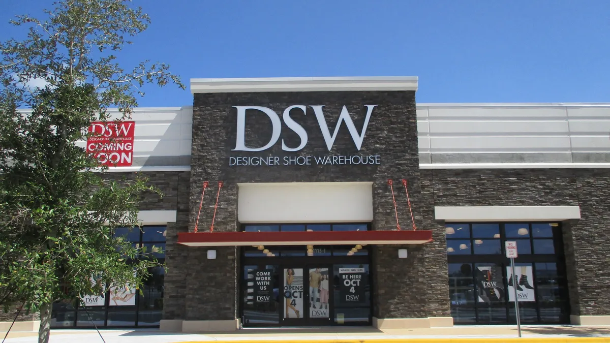 A brick storefront with a DSW sign on it.