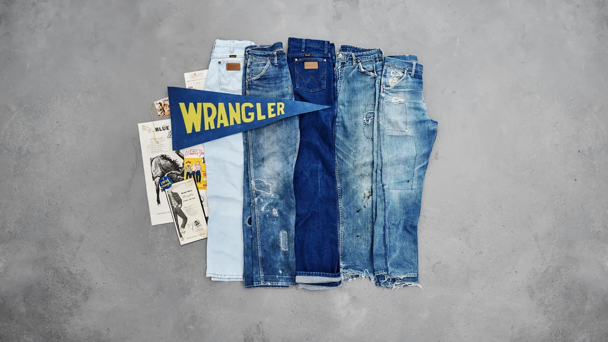 Several pairs of Wrangler jeans are folded in half and placed next to each other.