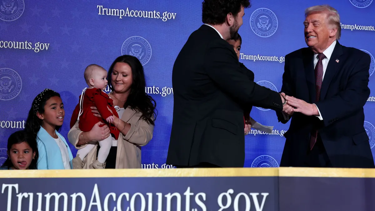 President Donald Trump invites a family onto the stage to speak during the Treasury Department's Trump Accounts Summit at Andrew W. Mellon Auditorium on Jan. 28, 2026, in Washington, D.C.
