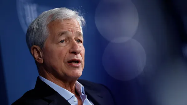 The CEO of JPMorgan Chase, Jamie Dimon, speaks in front of a blue background