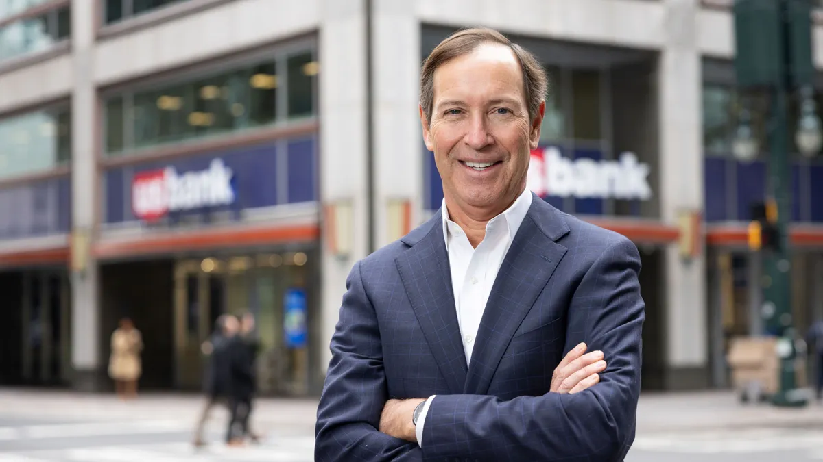 U.S. Bank executive Dee O'Dell poses in front of a U.S. Bank branch