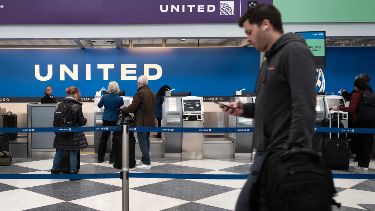 Passengers check in for United Airlines flights at O'Hare International Airport.