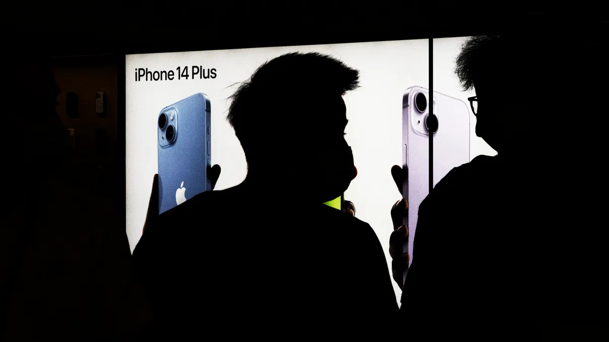 Customers line up at an Apple Store to pickup their orders of the new iPhone 14 on September 16,2022 in Wuhan. Hubei, China.