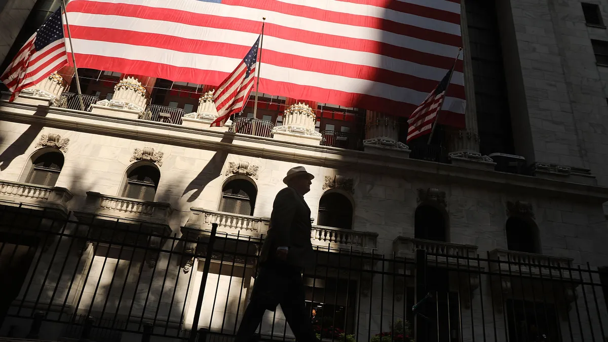 A man walks by the New York Stock Exchange (NYSE) in New York City.