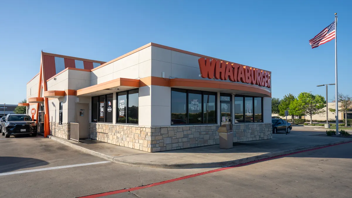 An exterior view of a whataburger restaurant including its drive-thru