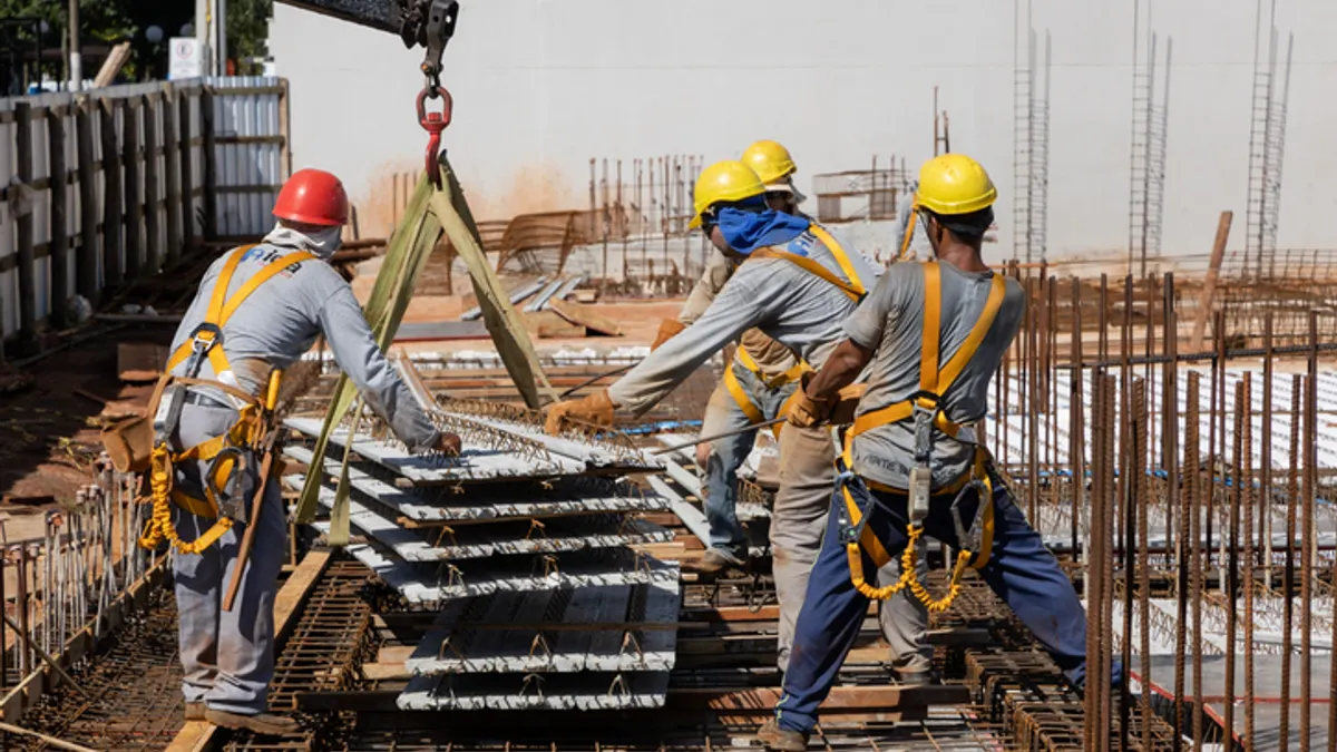 A group of construction workers on a building.