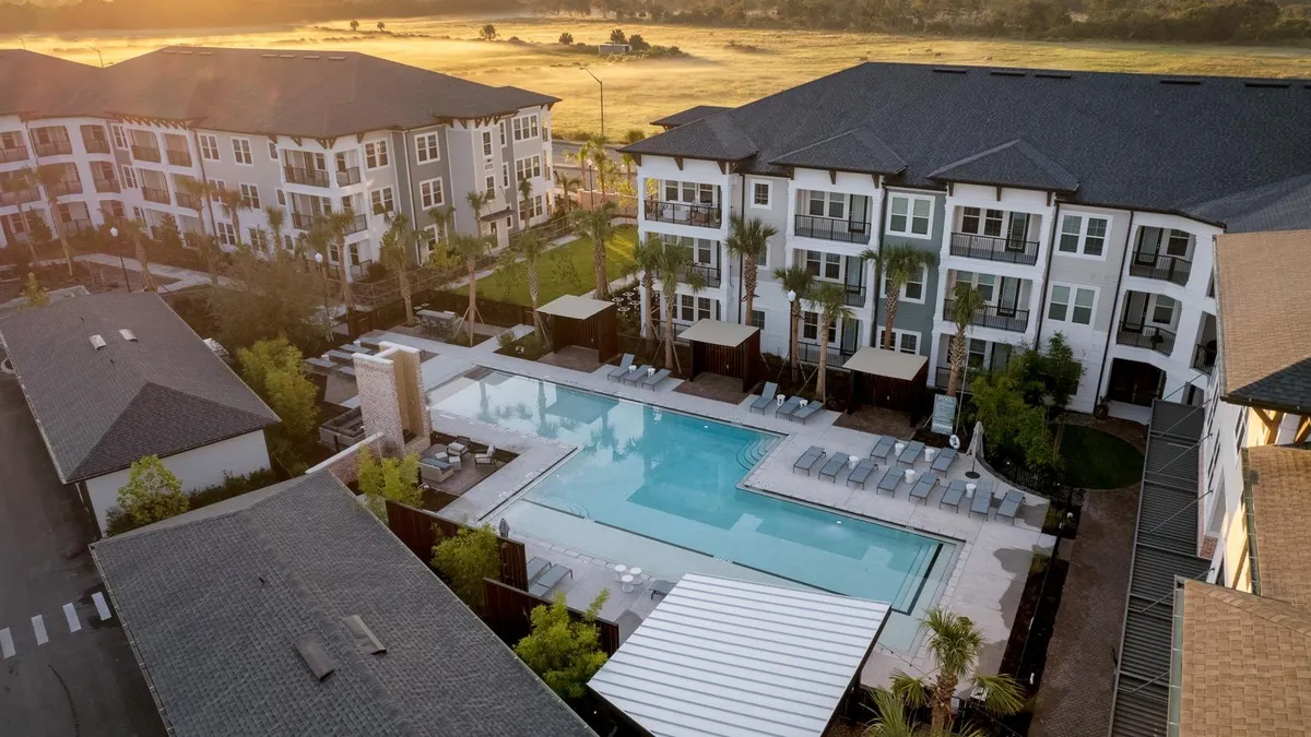 A pool area at a low-rise apartment building.