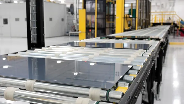 First Solar modules being manufactured in the United States on an assembly line inside a factory.