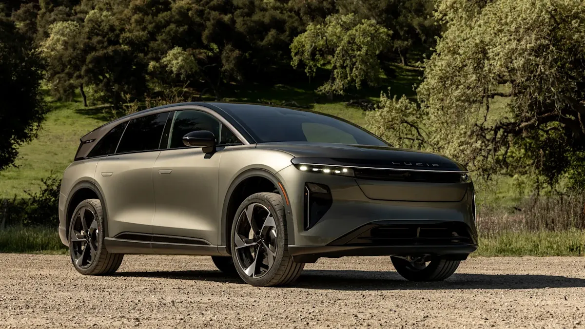 A Lucid Gravity electric SUV parked outdoors with greenery in the background.