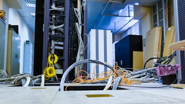 A raised floor and suction tool in the server room of a data center.