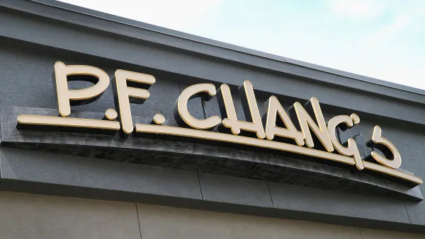 A zoomed in image of a building with gold signage. The sign says "P.F. Chang's."