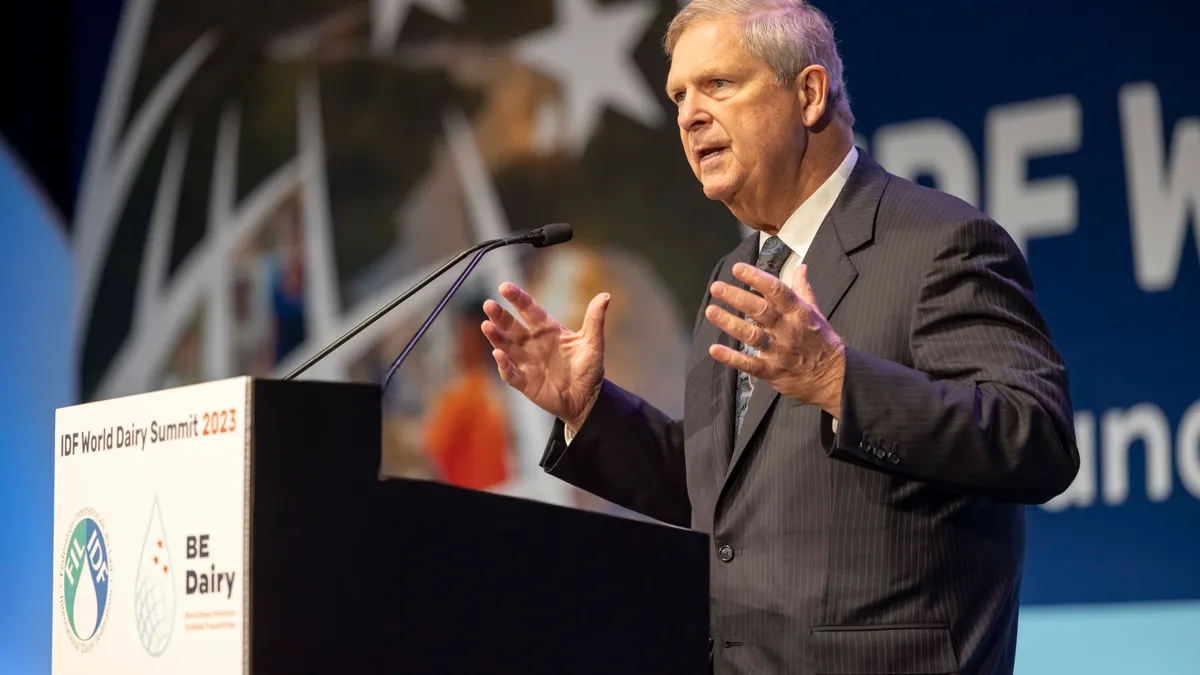 USDA Secretary Tom Vilsack speaks behind a lectern.