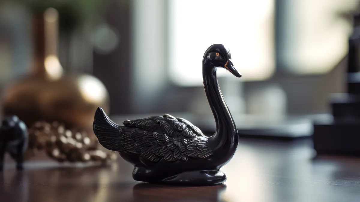 Small black swan statue on work desk