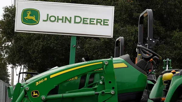 A sign posted in front of a Deere & Co. dealership