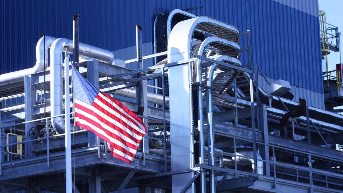 A U.S. flag hands outside a manufacturing plant.