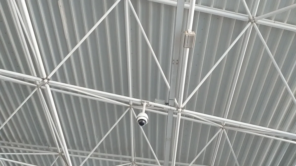 360 degree surveillance camera on white ceiling.