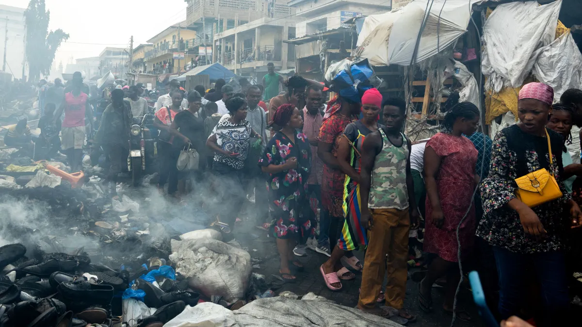 Shoppers looking at the damage caused by the fire at the Kantamanto Market.