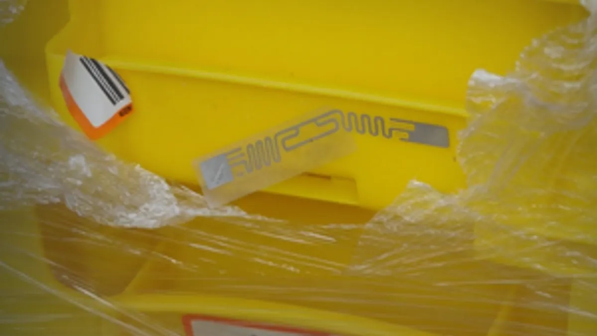 Damaged RFID label on yellow container