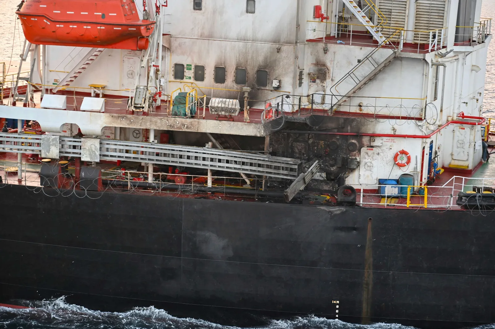 The scorched side view of a U.S.-owned ocean vessel.