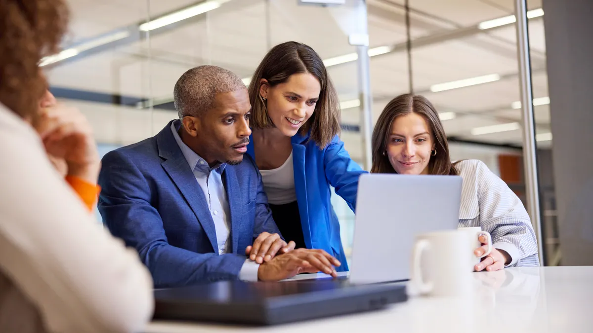 A team discussing over a laptop