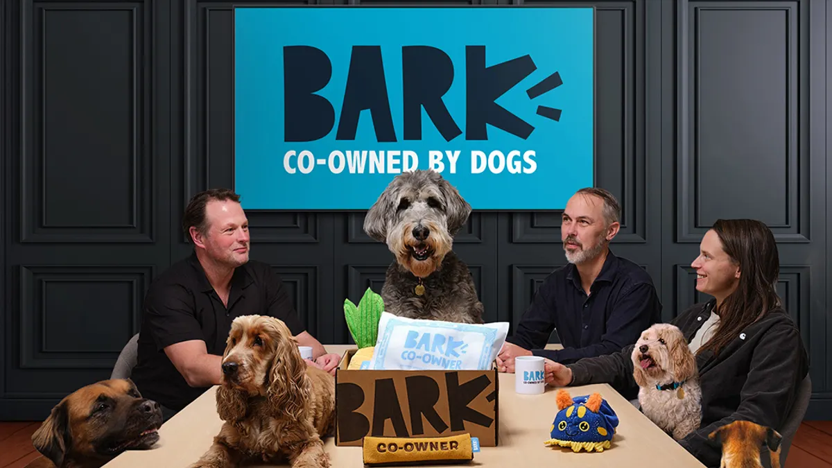 dogs and human at a table