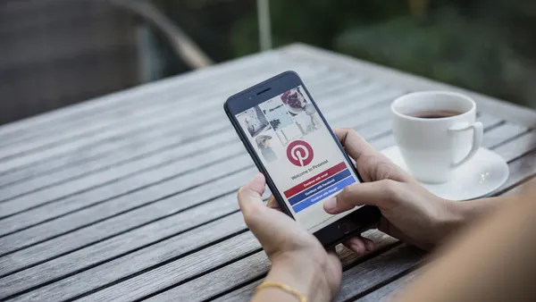 A person looks at the Pinterest app on their phone.