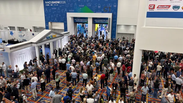 A crowd of people way to enter a room. A sign on the wall reads ROI Return On Insight. NACS SHow 2026.