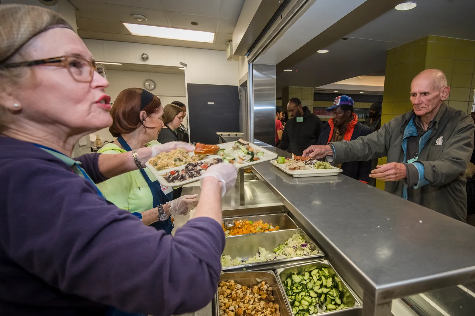 Volunteers serving lunch at The Beacon, a Houston-based service provider for individuals experiencing homelessness. The organization is part of the Houston region's continuum of care.